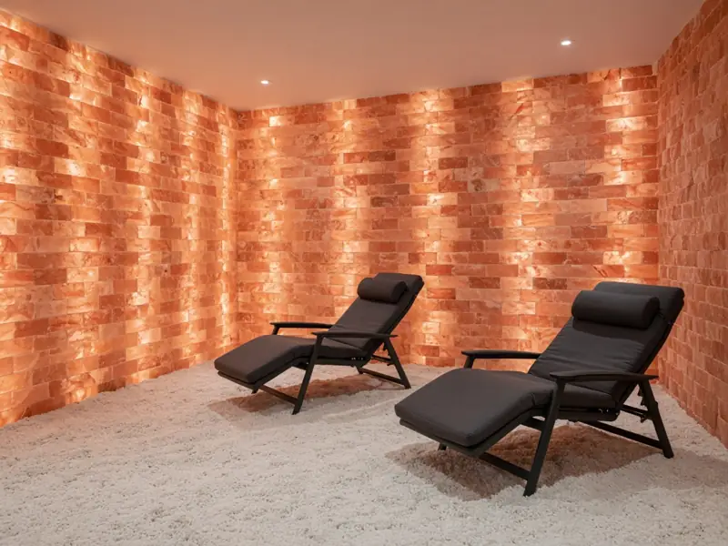 A backlit wall of pink salt bricks